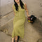 model wearing olive crinkle midi skirt with shaped shell buttons on the top and matching tank