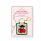 tan needlepoint keychain kit with green trim and red and pink cherry print and gold hardware
