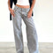 model wearing light grey low rise wide leg denim and white tank