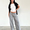 model wearing light grey low rise wide leg denim and white tank