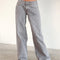 model wearing light grey low rise wide leg denim and white tank