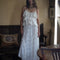 model wearing white asymmetric maxi skirt with lace and embroidery detail