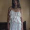 model wearing white tiered lacy tank with matching skirt