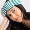 model wearing cabana green and white stripe weighted eye mask around their head