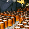 model filling amber jars with candle wax