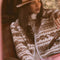 model wearing cropped white zip up jacket with brown alpine print