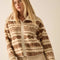 model wearing cropped white zip up jacket with brown alpine print