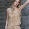 model wearing sand vest with lace detail, embroidered daisy print and tie front
