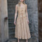 model wearing sand vest with lace detail, embroidered daisy print and tie front and matching skirt