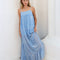 model wearing light blue maxi dress with ruffle hem and white floral print