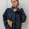 model wearing oversized high neck denim cropped jacket