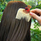 up close of cream pocket comb with teddy bear holding a red heart on the top