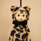 up close of cute plush dressed as a leopard and has a vintage circle face