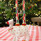 set of 2 red, green and white checkered taper candlesticks on a table arrangement