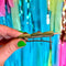 side view of alligator claw of set of two olive trio hair clips