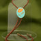 displayed teal and orange poppy bolo tie with brown cord and gold tips