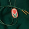 red tulip bolo tie with green cord and gold tips on a green ground