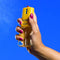 model spraying vacation by vacation sunscreen body mist