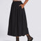 side view of model wearing flowy black midi skirt