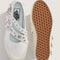 top and bottom view of white mary jane shoes with two buckle straps with grommet details and white sole