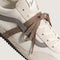 up close of vans super low pro with brown, beige and cream with brown wraparound laces
