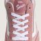 up close of pink suede mules with white iconic vans stripe