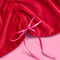 up close of red velvet cinched tree skirt with red satin bows