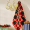 cotton terry checkered kitchen towel with alternating tomato and olive print hanging in a kitchen