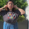 model wearing vintage black tee with colorful 'out of office' across the front