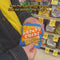 model putting 5 bags of potato chips in a realistic potato chip print shopper bag
