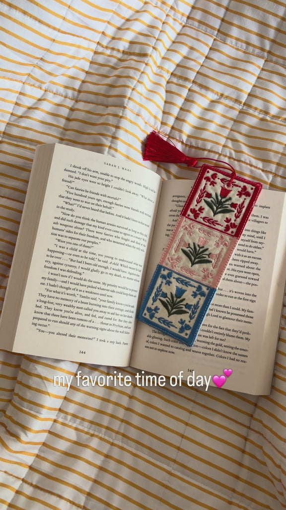 colorful embroidered folk bookmark inside a book pages