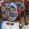model packing with blue and white folk floral duffel bag