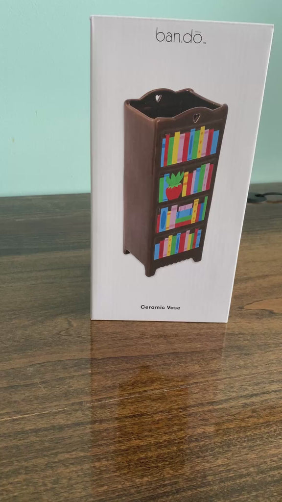 model unboxing brown bookshelf vase with colorful book shelves