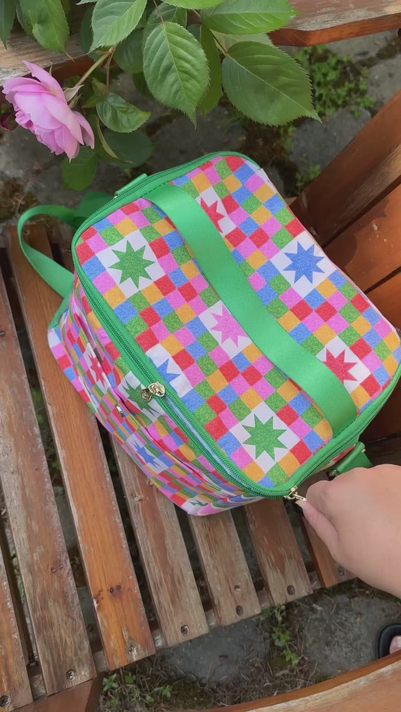 model pulling colorful stadium cup set out of starburst cooler bag.