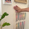 model hanging colorful lunar phases poster on their wall
