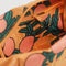 close up interior shot of dopp kit with handle in marigold with all over orange tree pattern