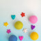 editorial image of wool dryer balls and shaped eco air fresheners in various colors