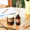 los angeles standard soy candle next to reed diffuser